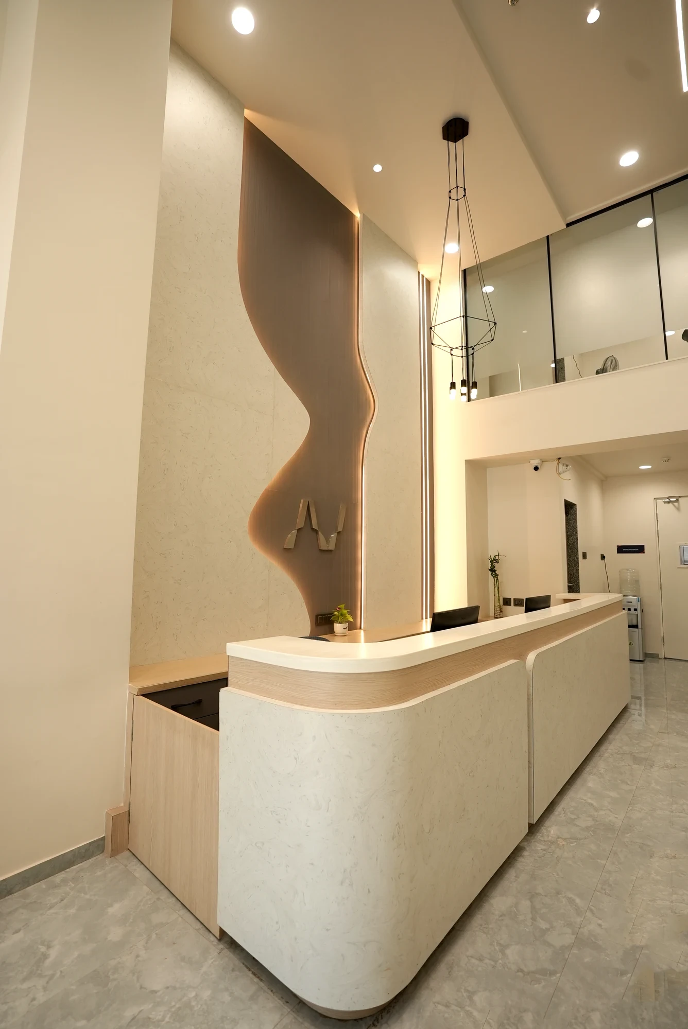 Curved reception desk and illuminated AV mark at AV Diagnostics